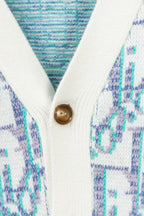 Cardigan front close-up showing gold-tone button and white ribbed edge