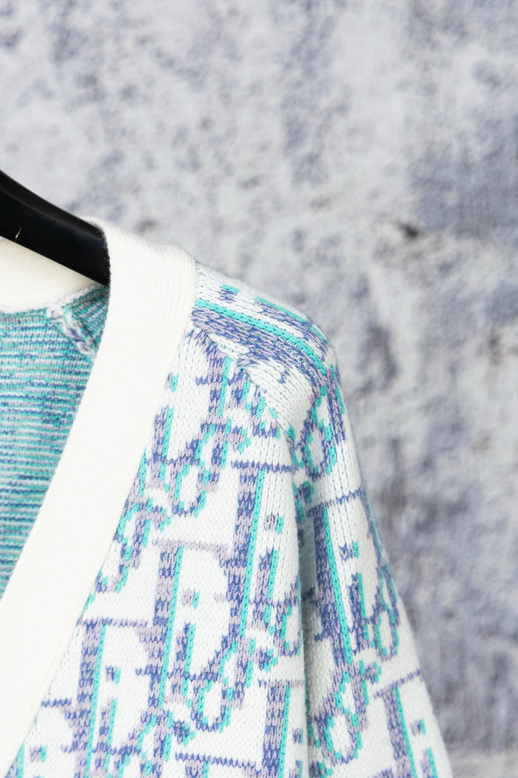 Cardigan shoulder and sleeve detail in blue-and-white textured pattern
