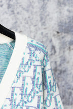 Cardigan shoulder and sleeve detail in blue-and-white textured pattern