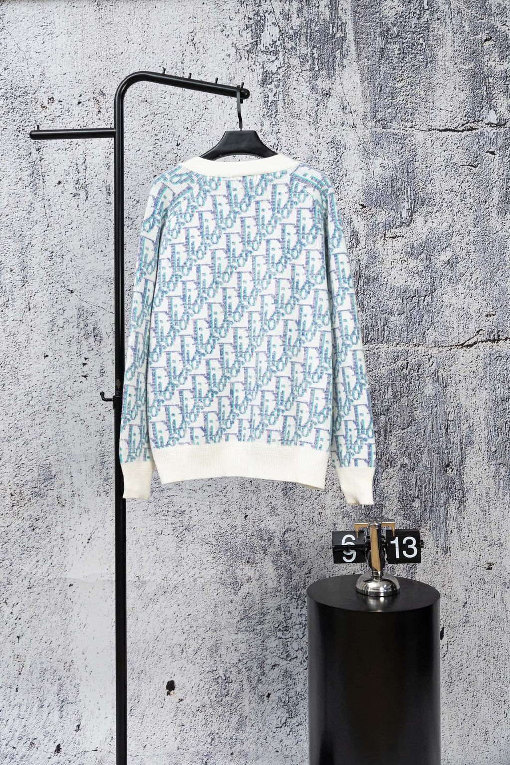 Long-sleeve knit cardigan sweater with blue-and-white geometric pattern and ribbed hem