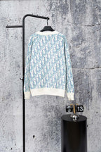 Long-sleeve knit cardigan sweater with blue-and-white geometric pattern and ribbed hem