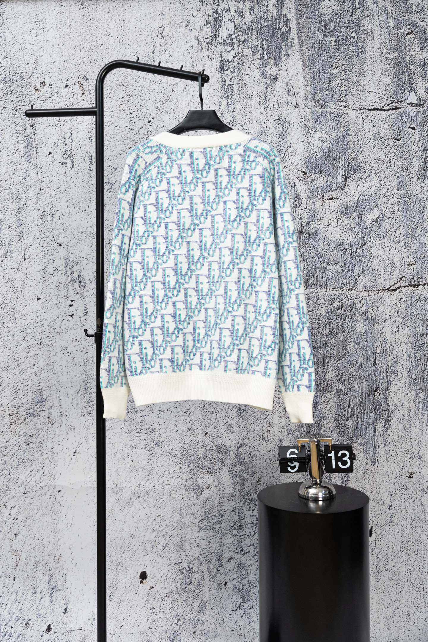 Long-sleeve knit cardigan sweater with blue-and-white geometric pattern and ribbed hem