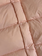 Moncler long puffer jacket, close-up of quilt seams and snap-button placket