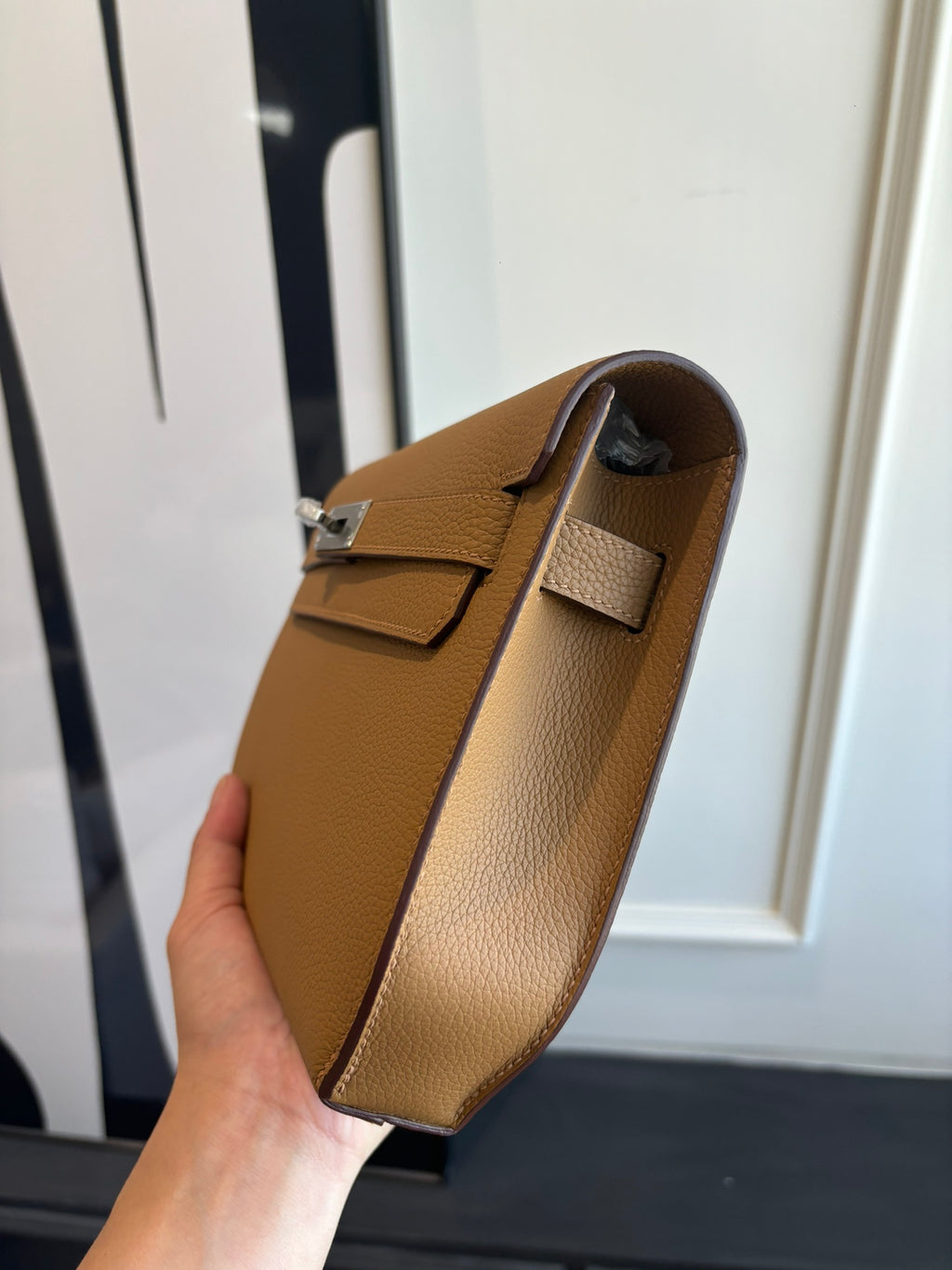 Hermes tan leather flap bag with top handle and side view