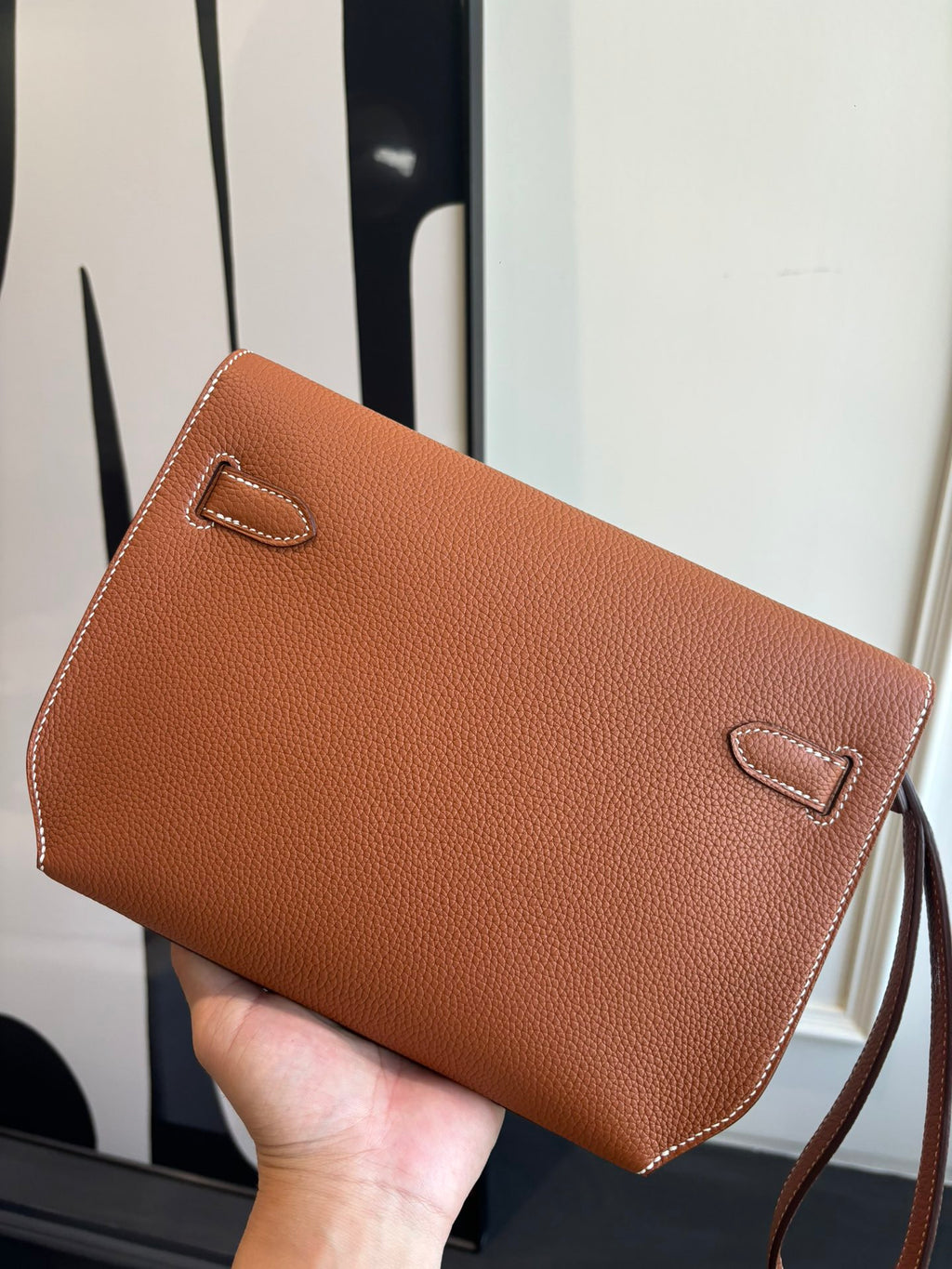 Hermes brown leather flap bag with stitched flap and decorative corner loops