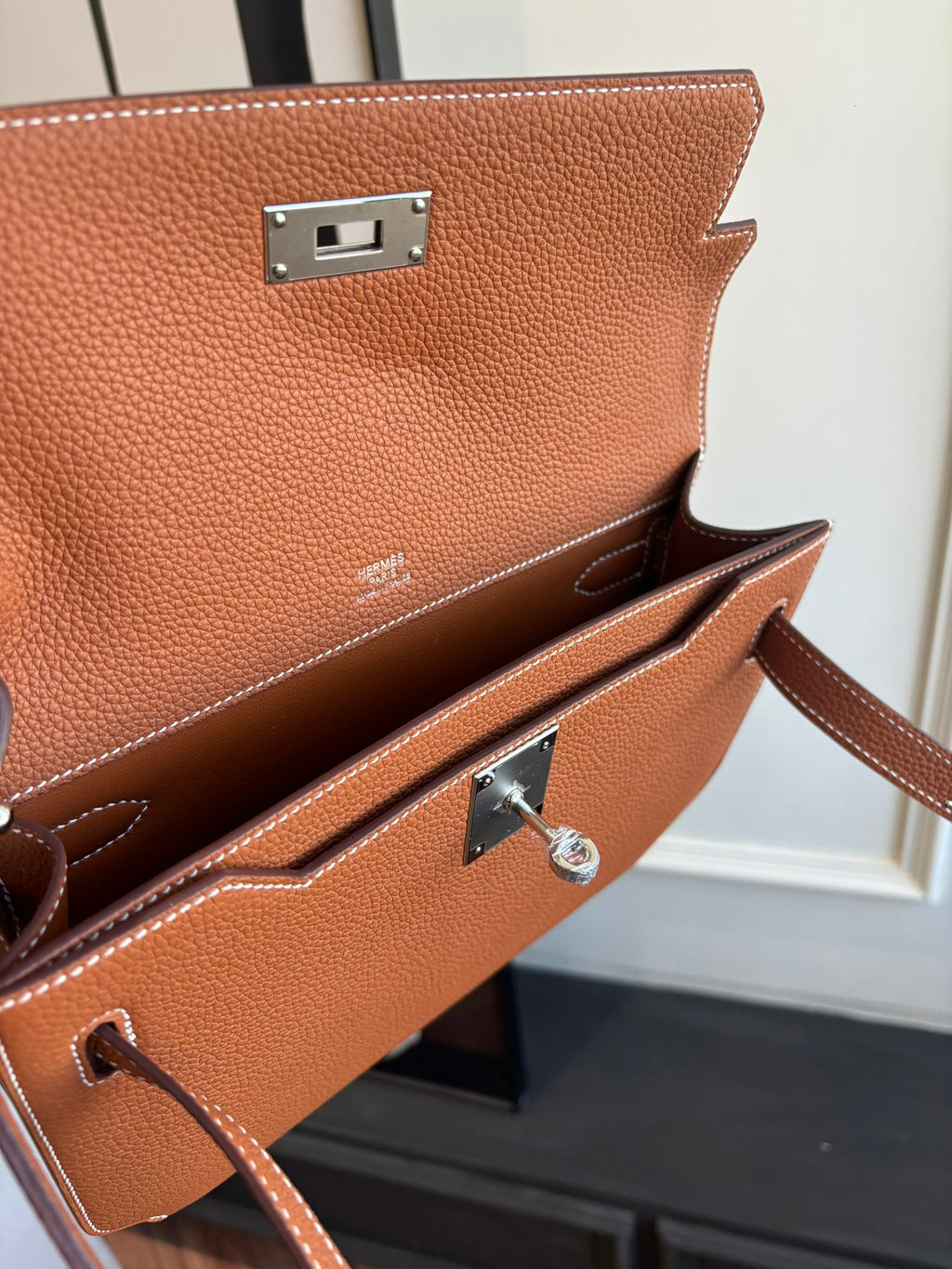 Hermes brown leather flap bag front hardware with silver clasp and strap loop