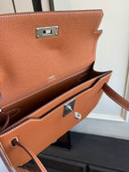 Hermes brown leather flap bag front hardware with silver clasp and strap loop