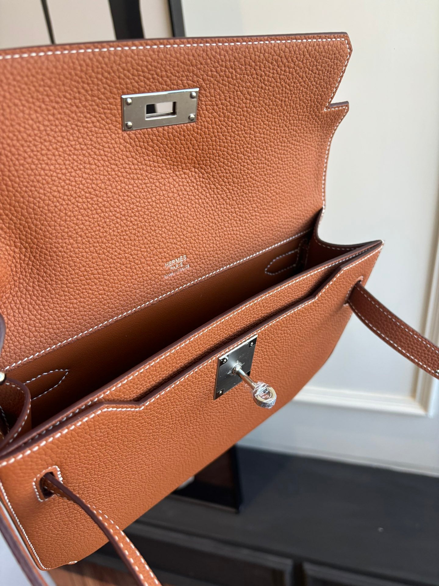 Hermes brown leather flap bag front hardware with silver clasp and strap loop