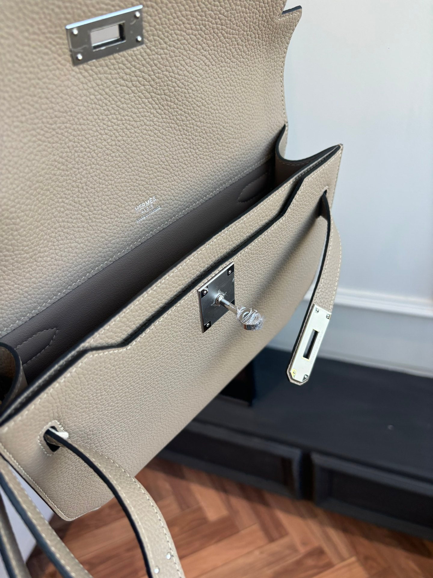 Hermes flap bag interior view showing silver-tone hardware and front clasp mechanism