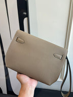 Hermes textured taupe leather flap bag with small front pocket and strap loops