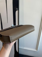 Hermes leather bag side profile, taupe flap with silver clasp and detachable strap