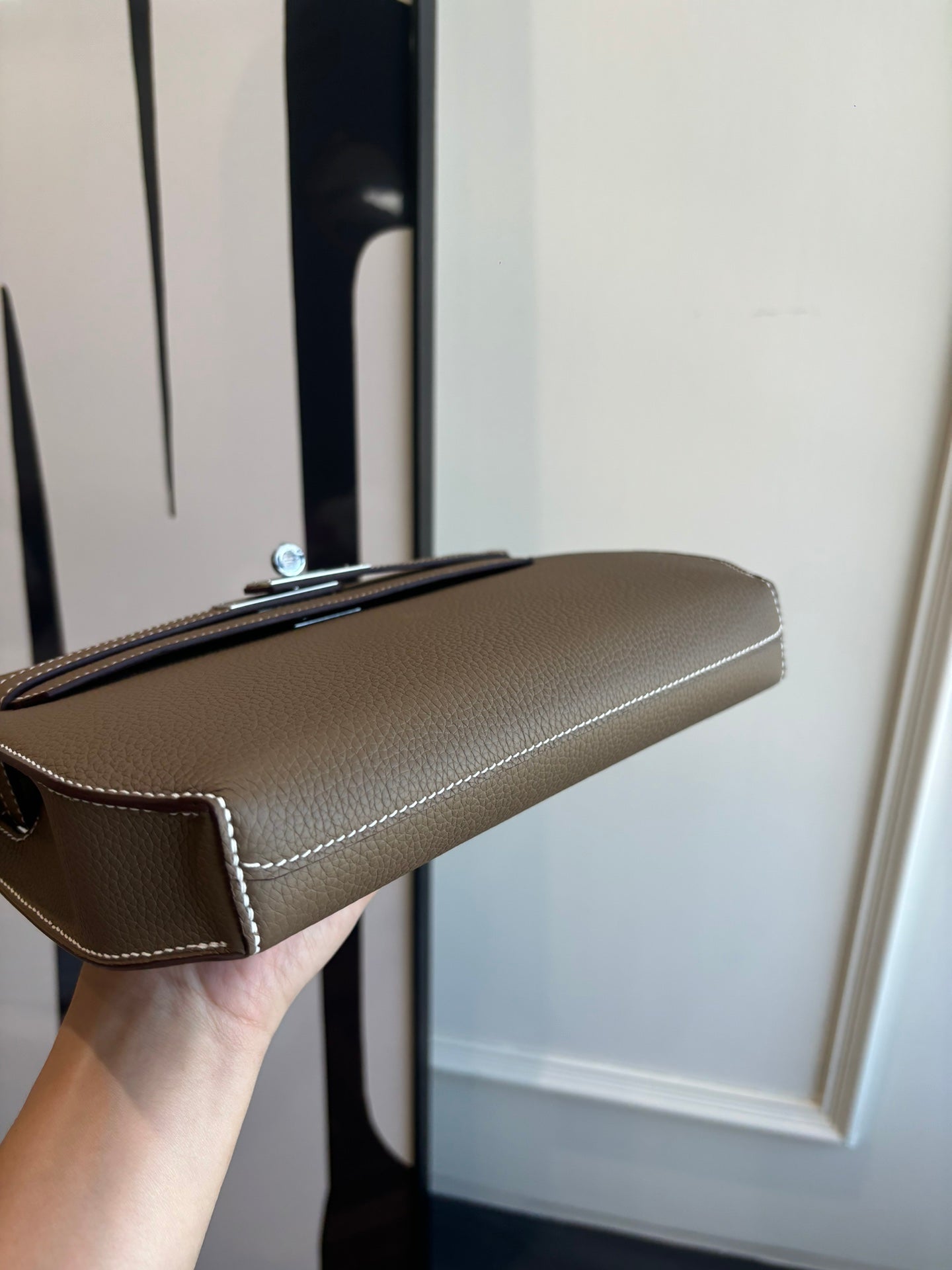 Hermes leather bag side profile, taupe flap with silver clasp and detachable strap