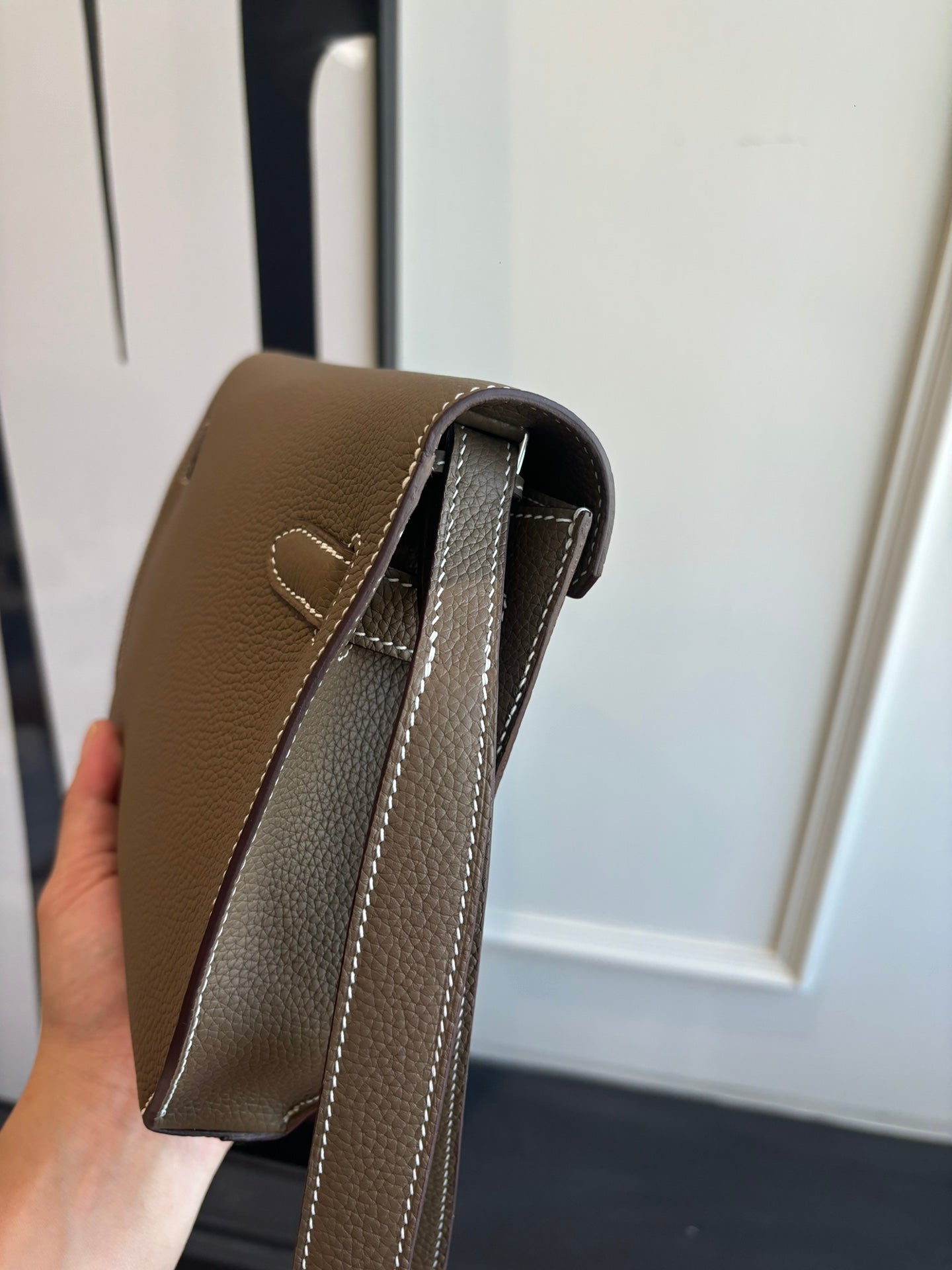 Hermes leather bag top edge close-up, taupe with inner lining and strap loops