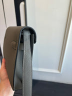 Gray leather shoulder bag open view showing inner lining and flap
