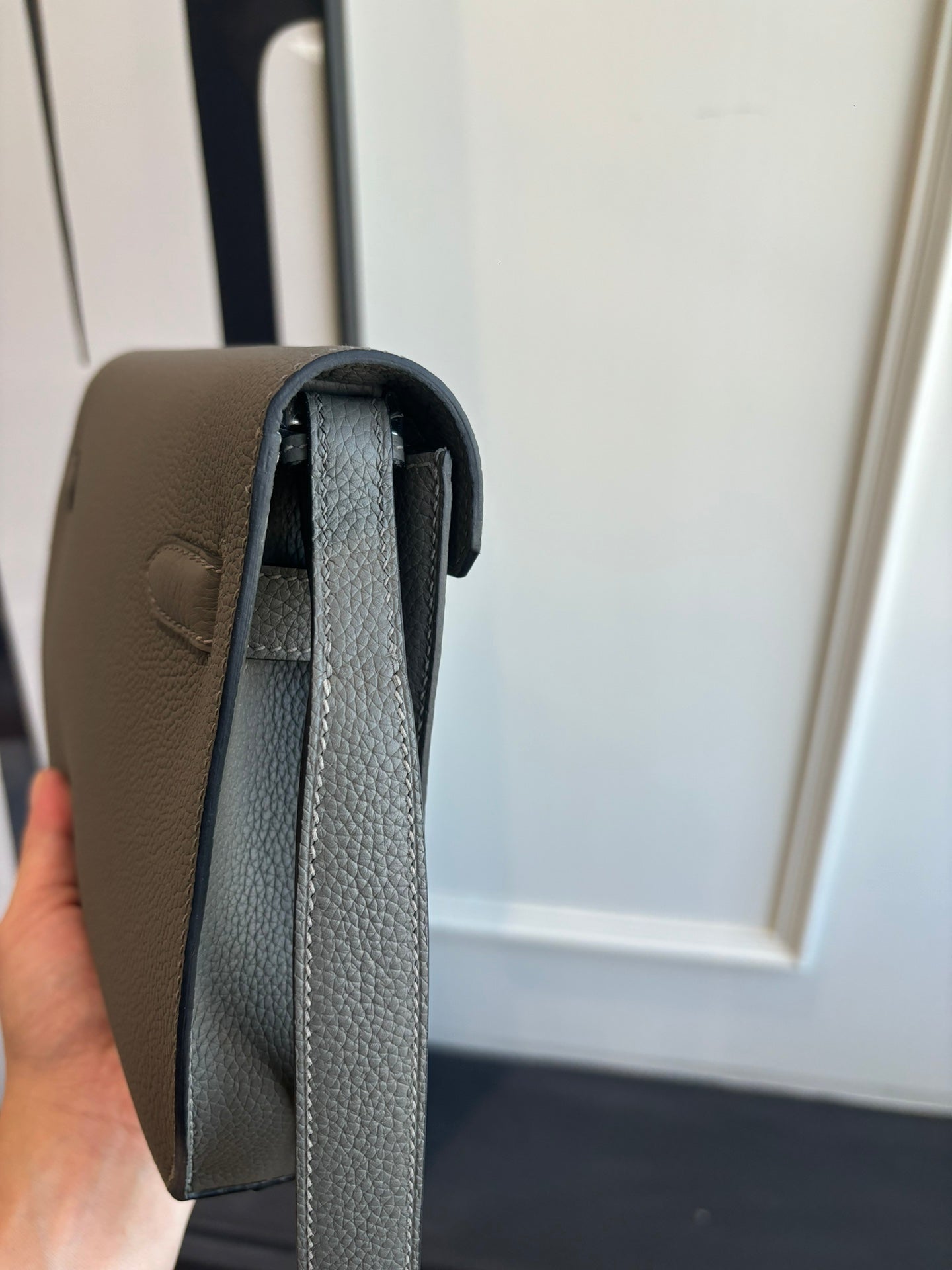 Gray leather shoulder bag open view showing inner lining and flap