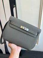 Gray leather crossbody bag with flap and gold-tone clasp