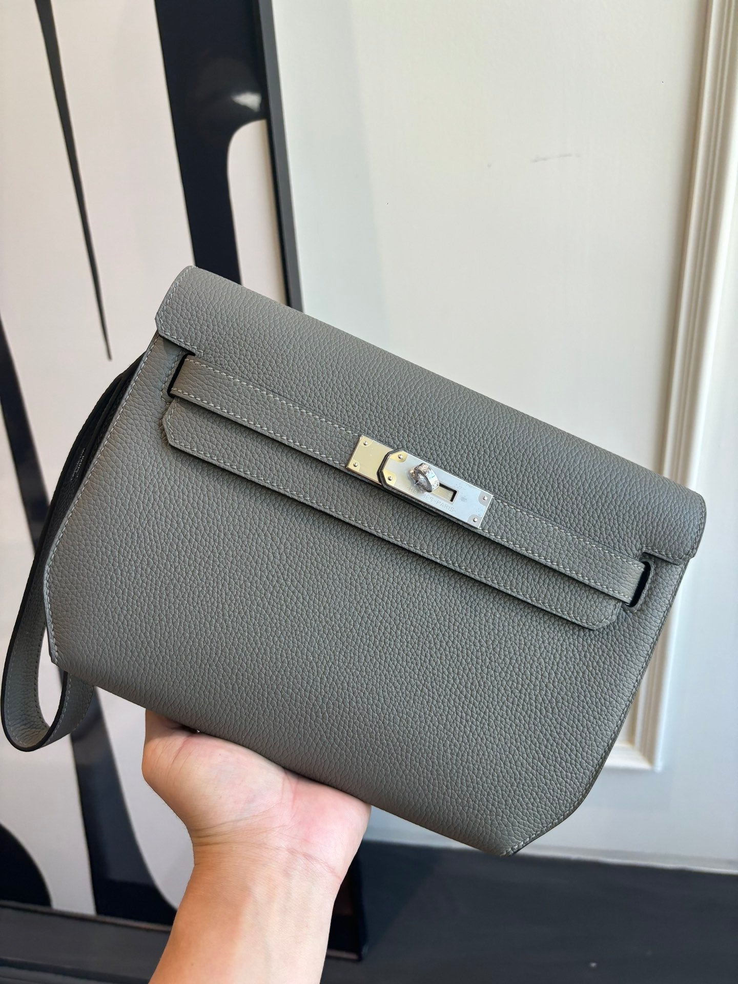 Gray leather crossbody bag with flap and gold-tone clasp