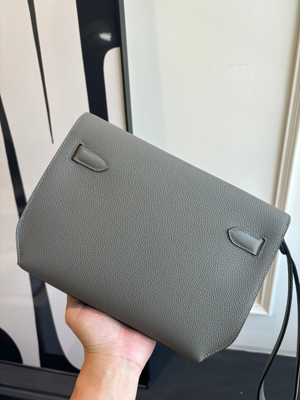 Gray leather flap bag with front pocket and loop strap