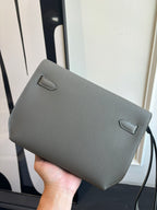 Gray leather flap bag with front pocket and loop strap