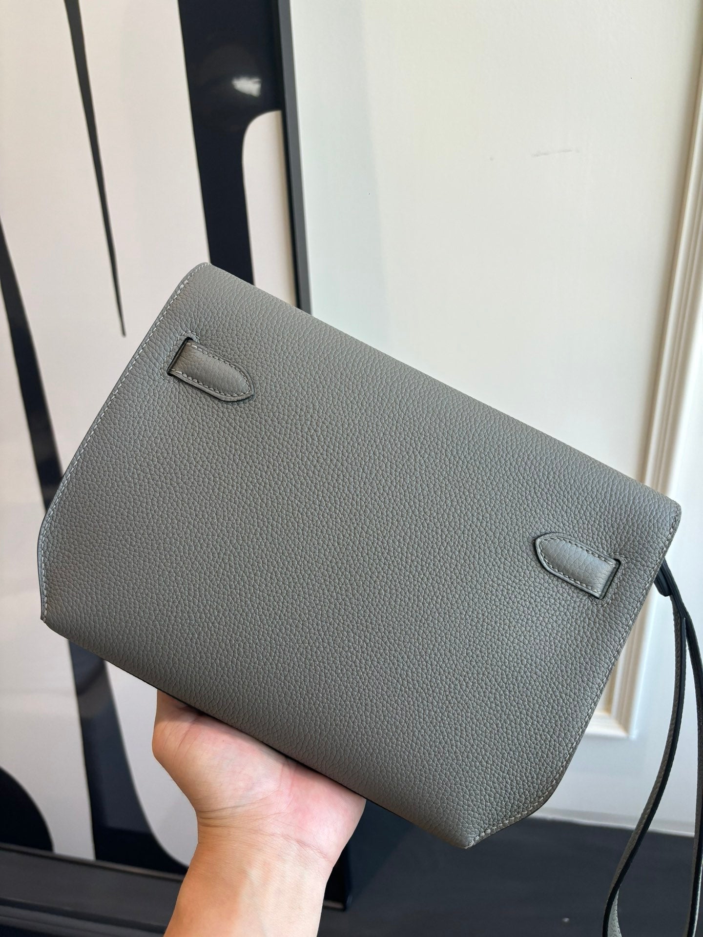 Gray leather flap bag with front pocket and loop strap