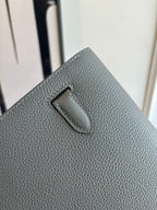 Gray leather bag back panel with stitched handle loop