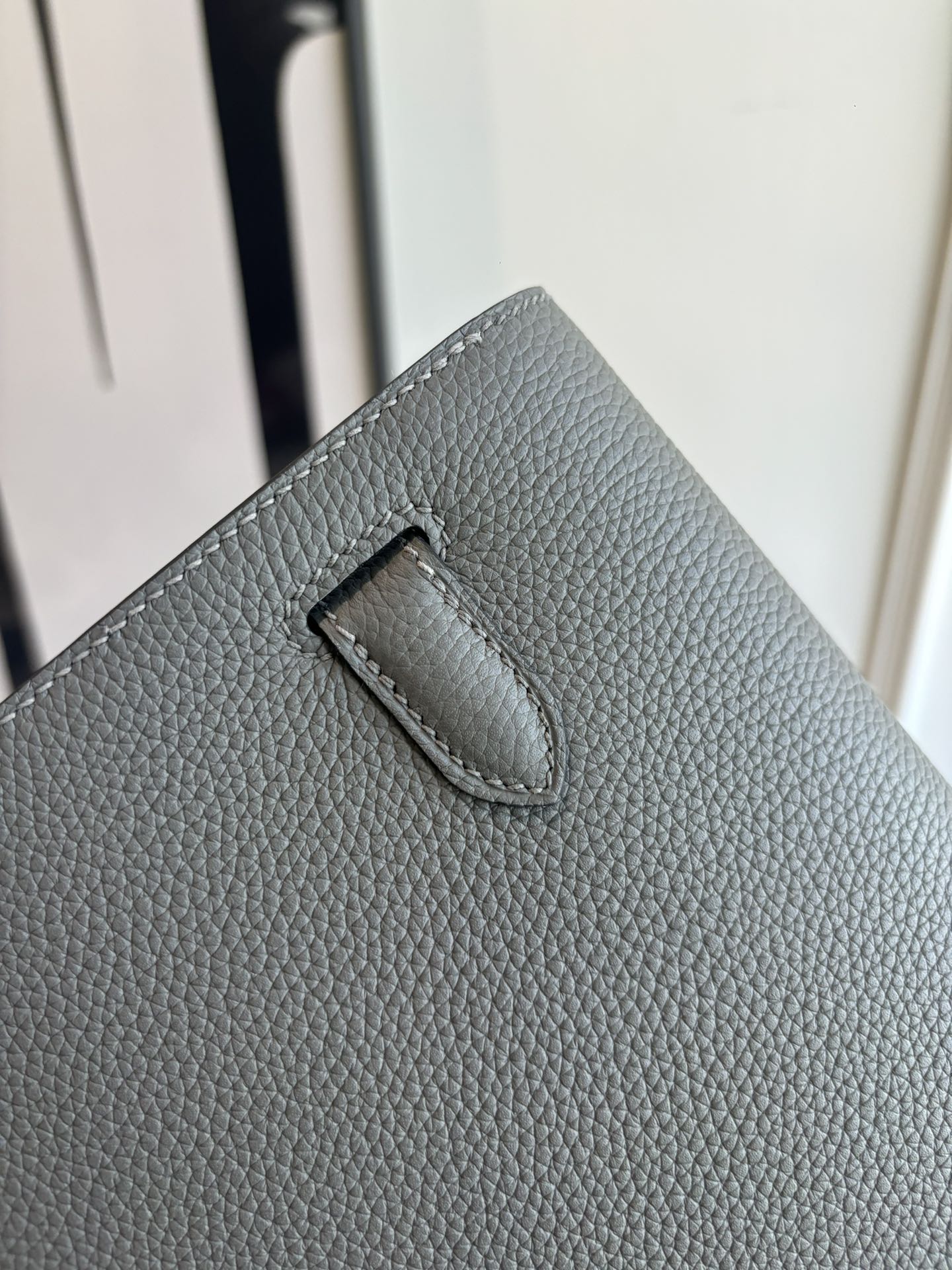 Gray leather bag back panel with stitched handle loop
