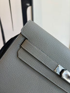 Gray leather flap bag detail with buckle strap and front clasp