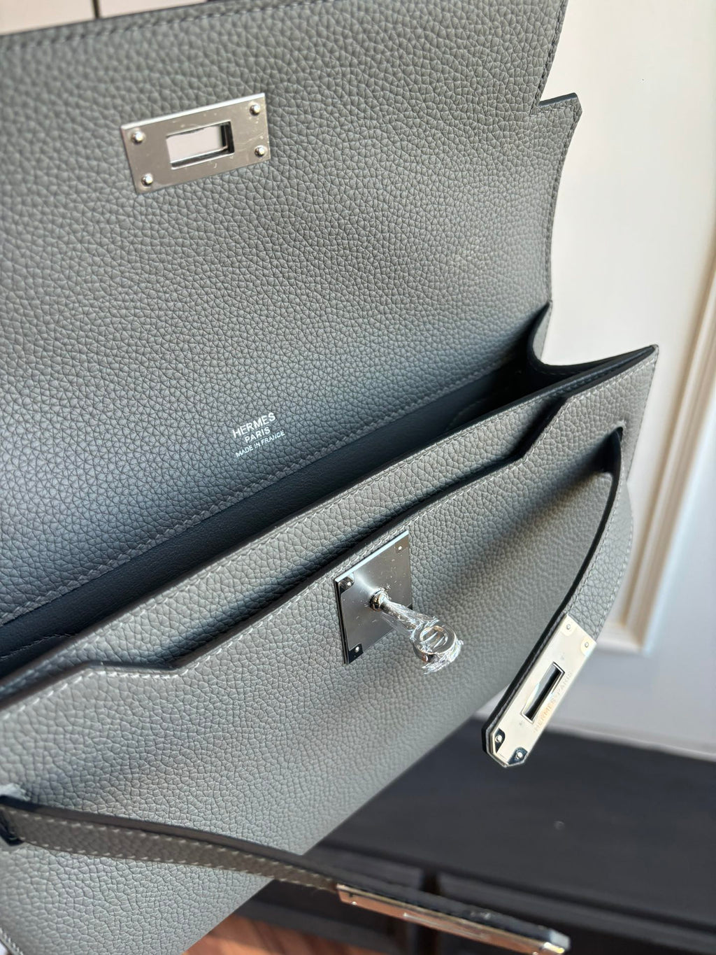Gray leather flap bag interior with lock clasp and strap hardware