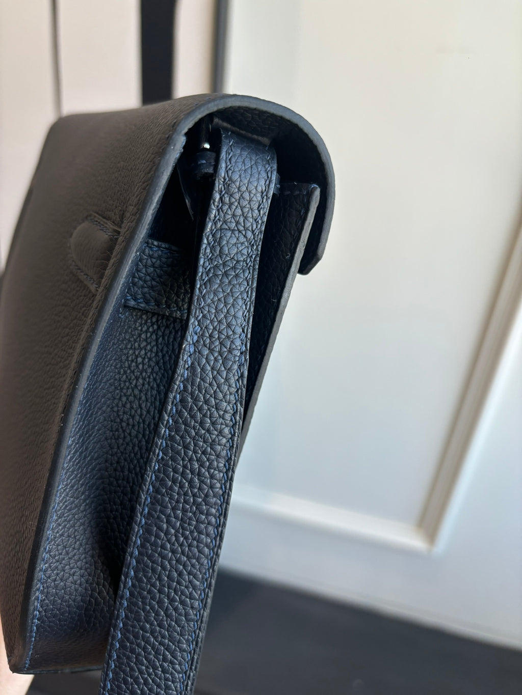 Hermes leather bag with textured strap and visible inner lining