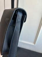 Hermes leather bag with textured strap and visible inner lining
