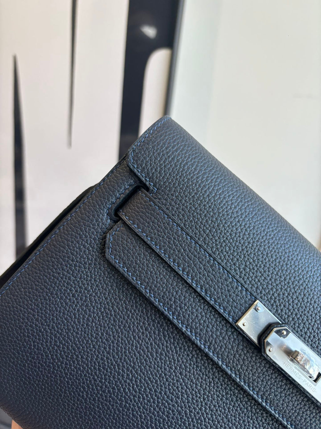 Hermes blue leather crossbody bag close-up of flap and silver-toned lock