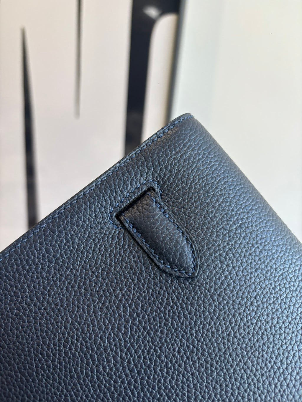 Hermès small shoulder bag back detail, textured dark leather with stitched tab