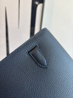 Hermès small shoulder bag back detail, textured dark leather with stitched tab