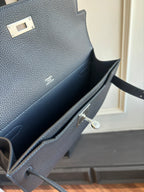 Hermès small shoulder bag interior view, dark lining with pocket and clasp