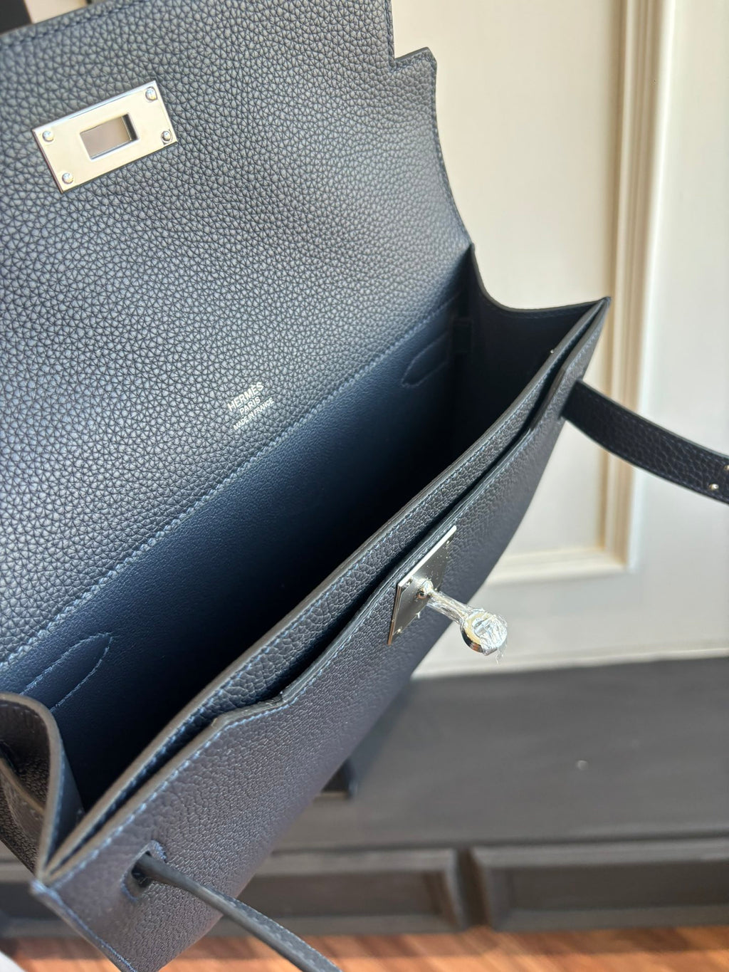 Hermes leather bag interior with clasp, inner compartment, and side pocket