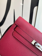 Hermes bag close-up of textured leather flap with silver hardware and latch.