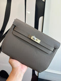 Gray pebbled leather clutch bag with front flap and turn-lock clasp