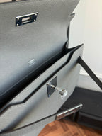 Hermes bag interior view with gold-tone hardware and accordion-style pocket