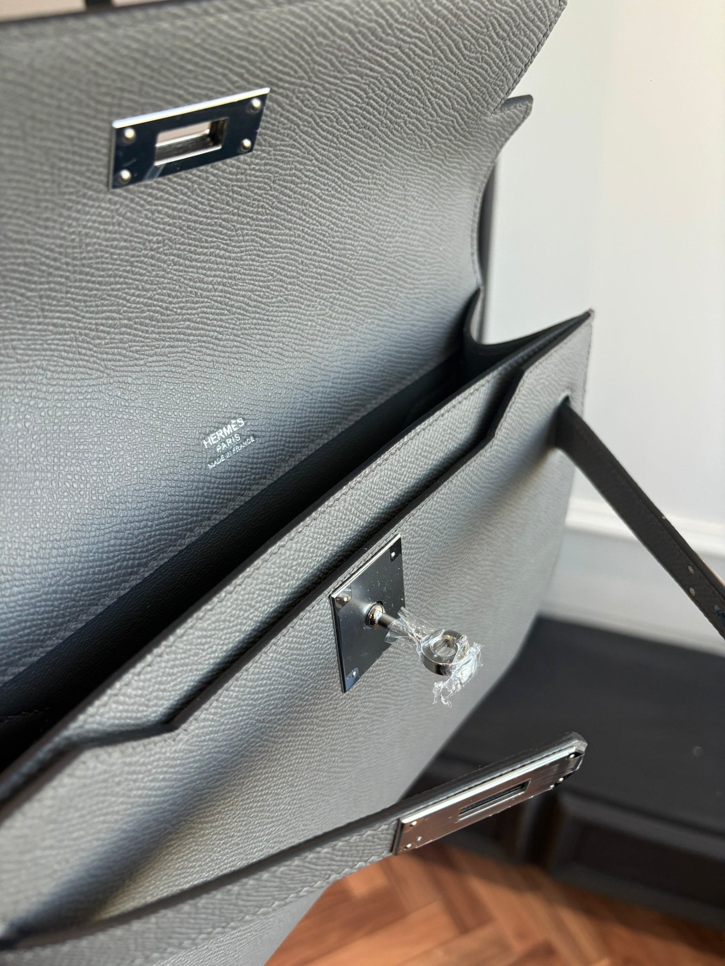 Hermes bag interior view with gold-tone hardware and accordion-style pocket