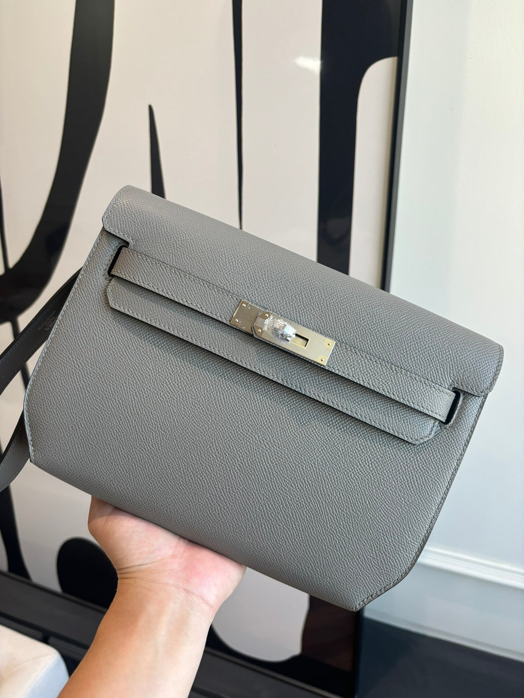 Hermes bag in light blue-gray textured leather, front flap with gold-tone turn-lock