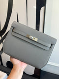 Hermes bag in light blue-gray textured leather, front flap with gold-tone turn-lock