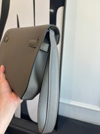 Hermes bag open side with curved top opening and light blue-gray leather lining