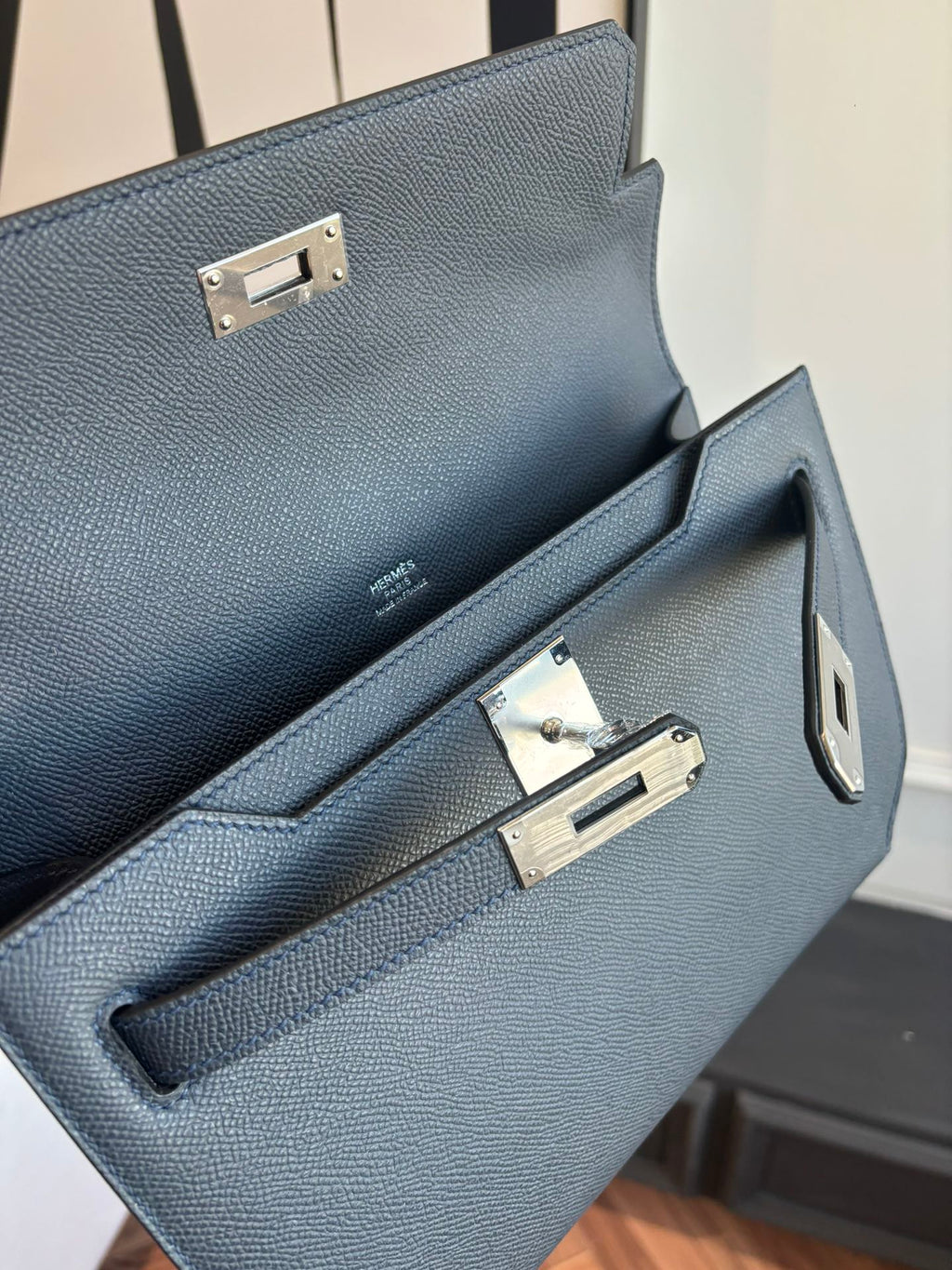 Hermes bag interior view with front pocket and gold clasps on pebbled leather