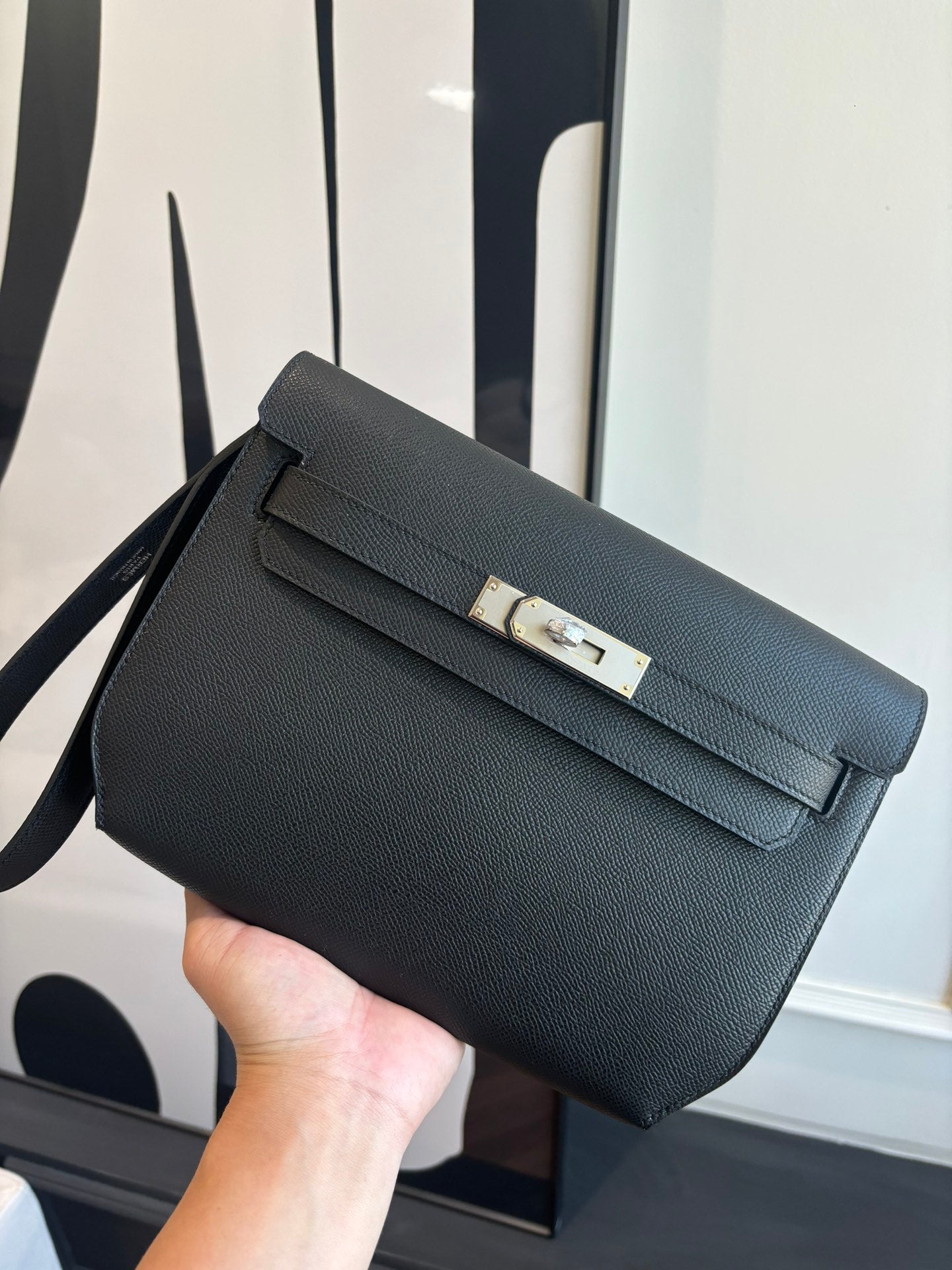Hermes bag in dark blue textured leather, front flap with silver turn-lock and strap