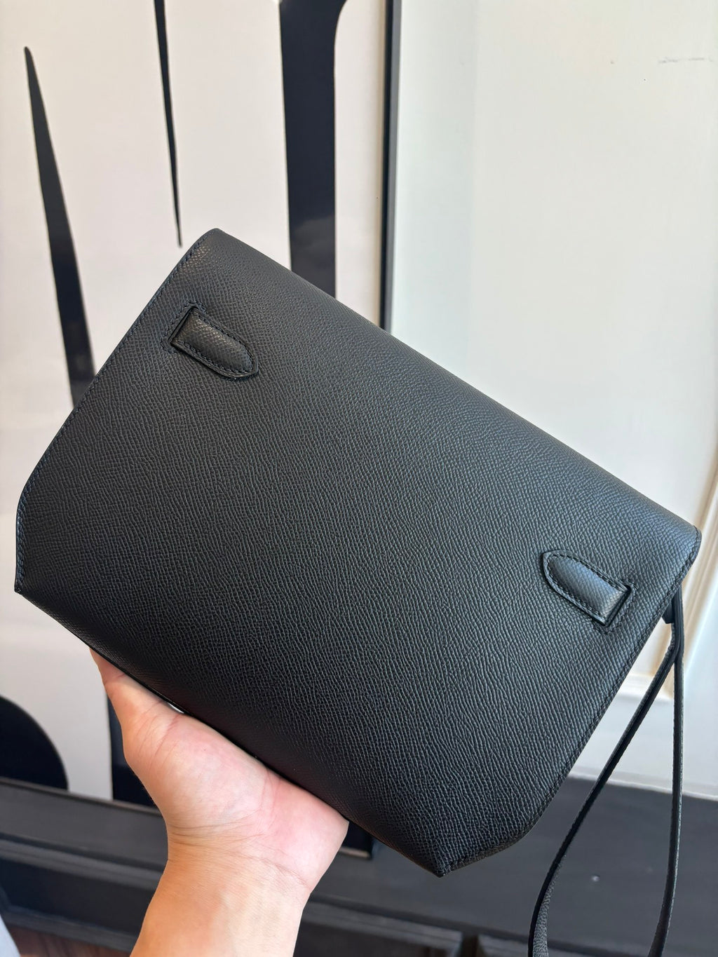 Flap bag front view with two fold-over corners and textured surface, dark blue
