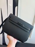 Hermes bag in dark textured leather, flap front with metal clasp and strap