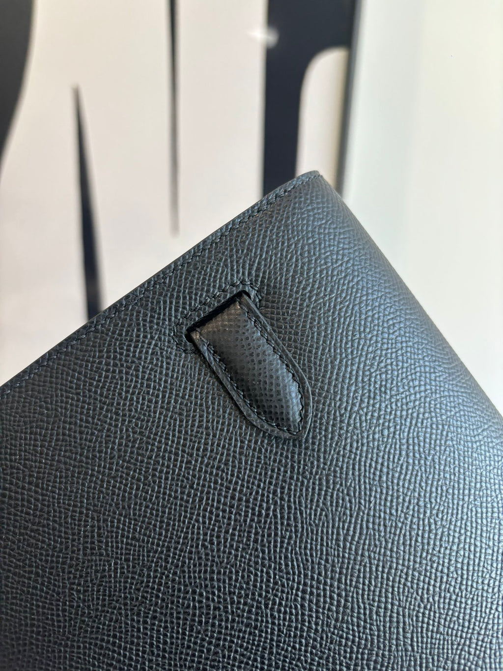 Hermes bag close-up of embossed flap detail and textured dark leather grain