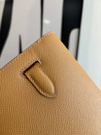 Hermes tan leather flap bag corner with stitched strap detail