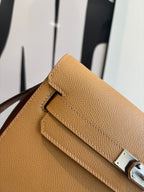 Hermes tan textured leather flap bag with silver lock and stitched trim