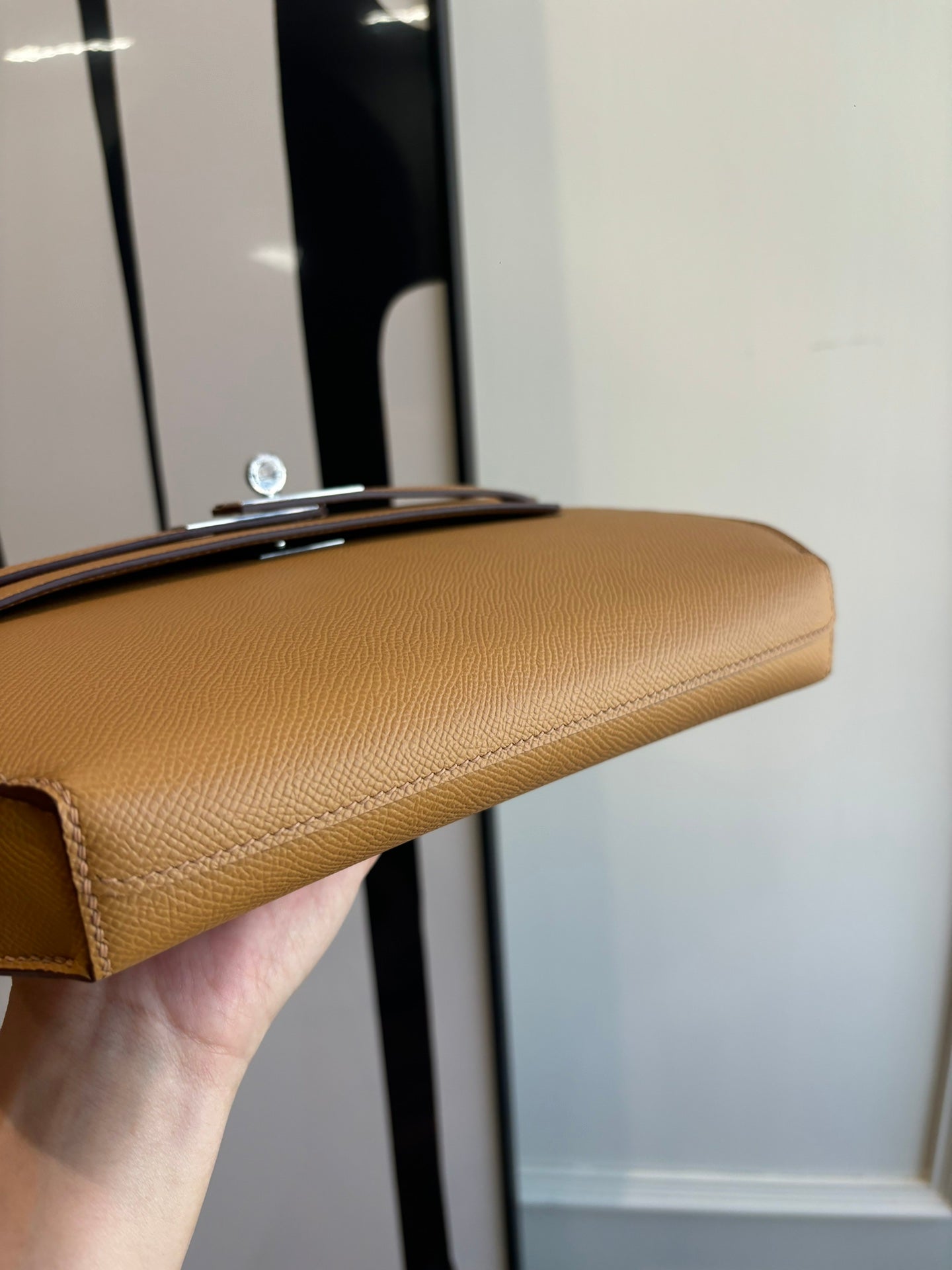 Hermes tan leather flap bag underside with silver hardware on top